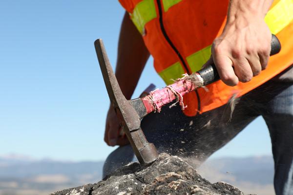 Man hammering a rock